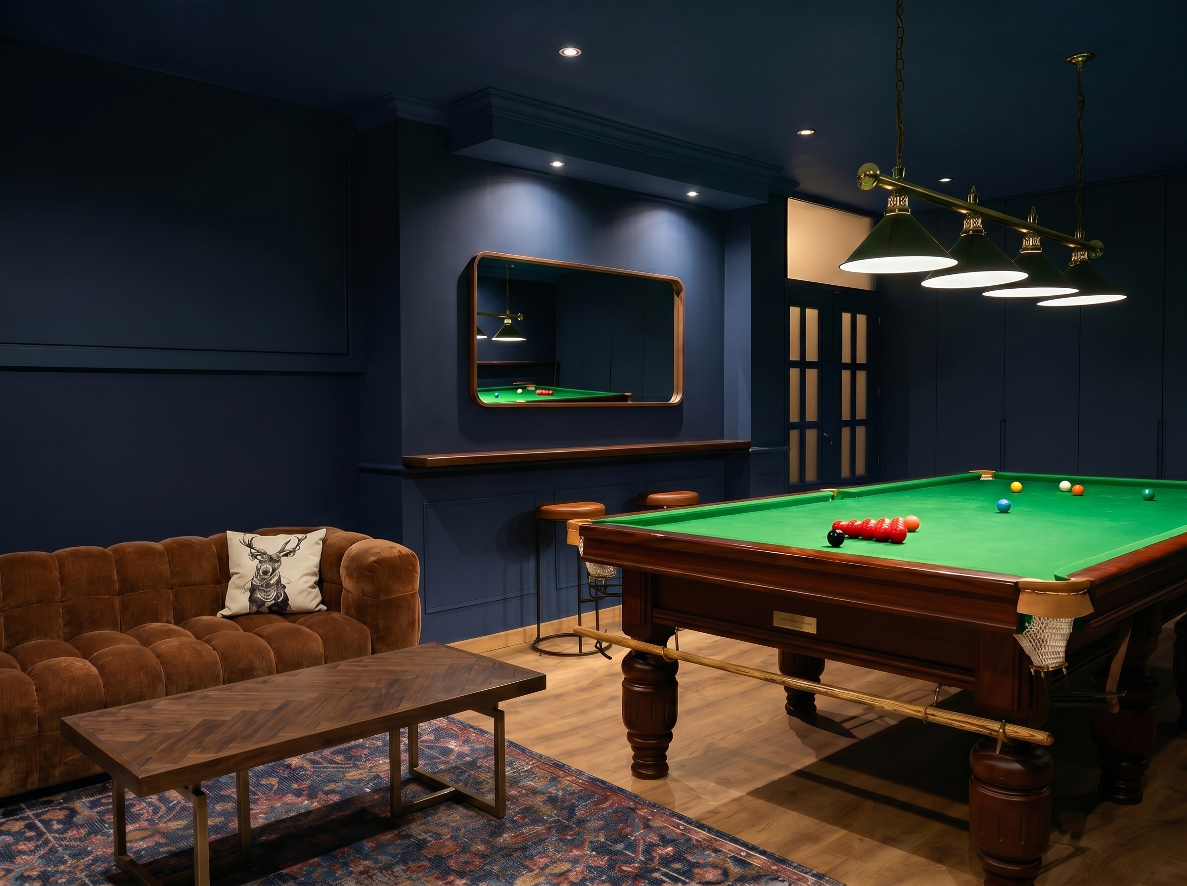 Games room in Málaga with full-size snooker table, brown velvet sofa and brass bar lighting, designed by The Dream Spaces